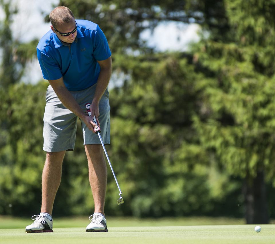 Andrew Cowan watches a putt
